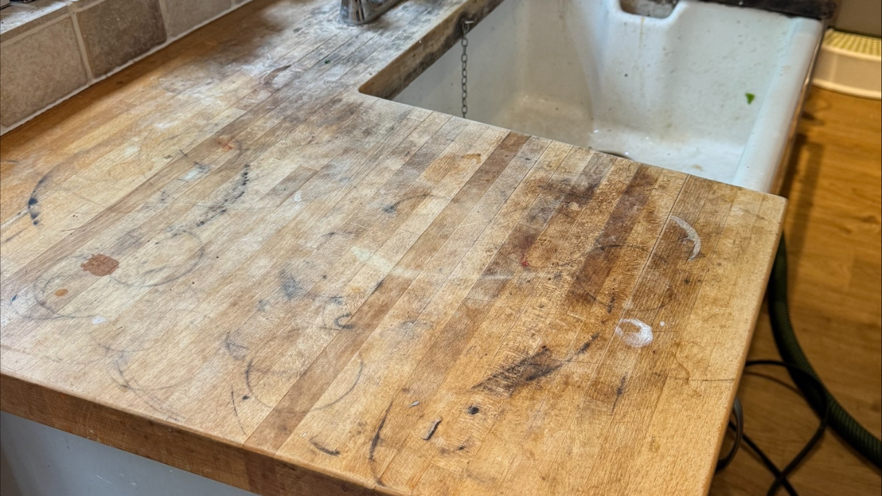 Worktop Refinishing in Bracknell before restoration on an oak butcher block kitchen worktop with engineered wood flooring